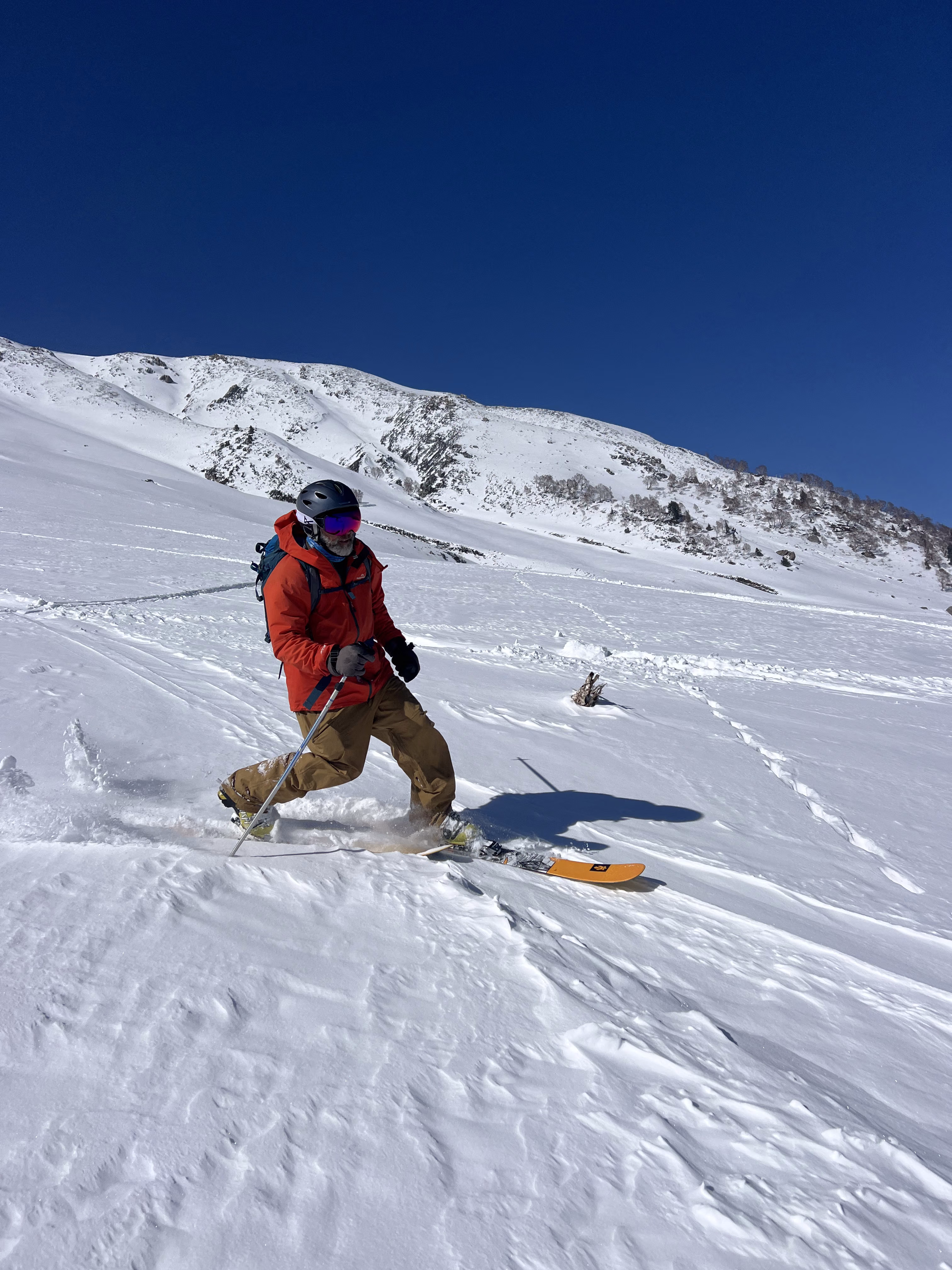 Freeride skier descending a steep untracked face on Apharwat